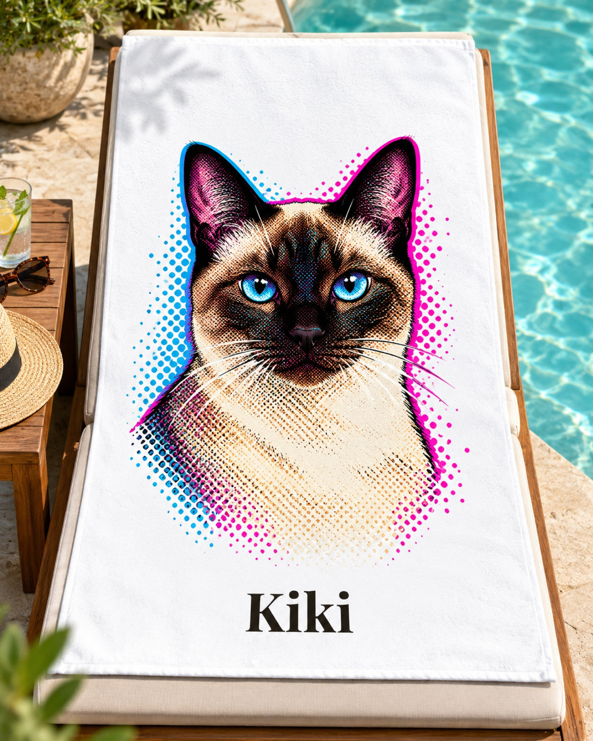 Badetuch mit Siamkatze im Pop-Art-Stil und Namen Kiki, das Tuch liegt auf einer Sonnenliege am Pool